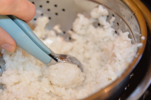Cogiendo arroz con una cuchara para helados
